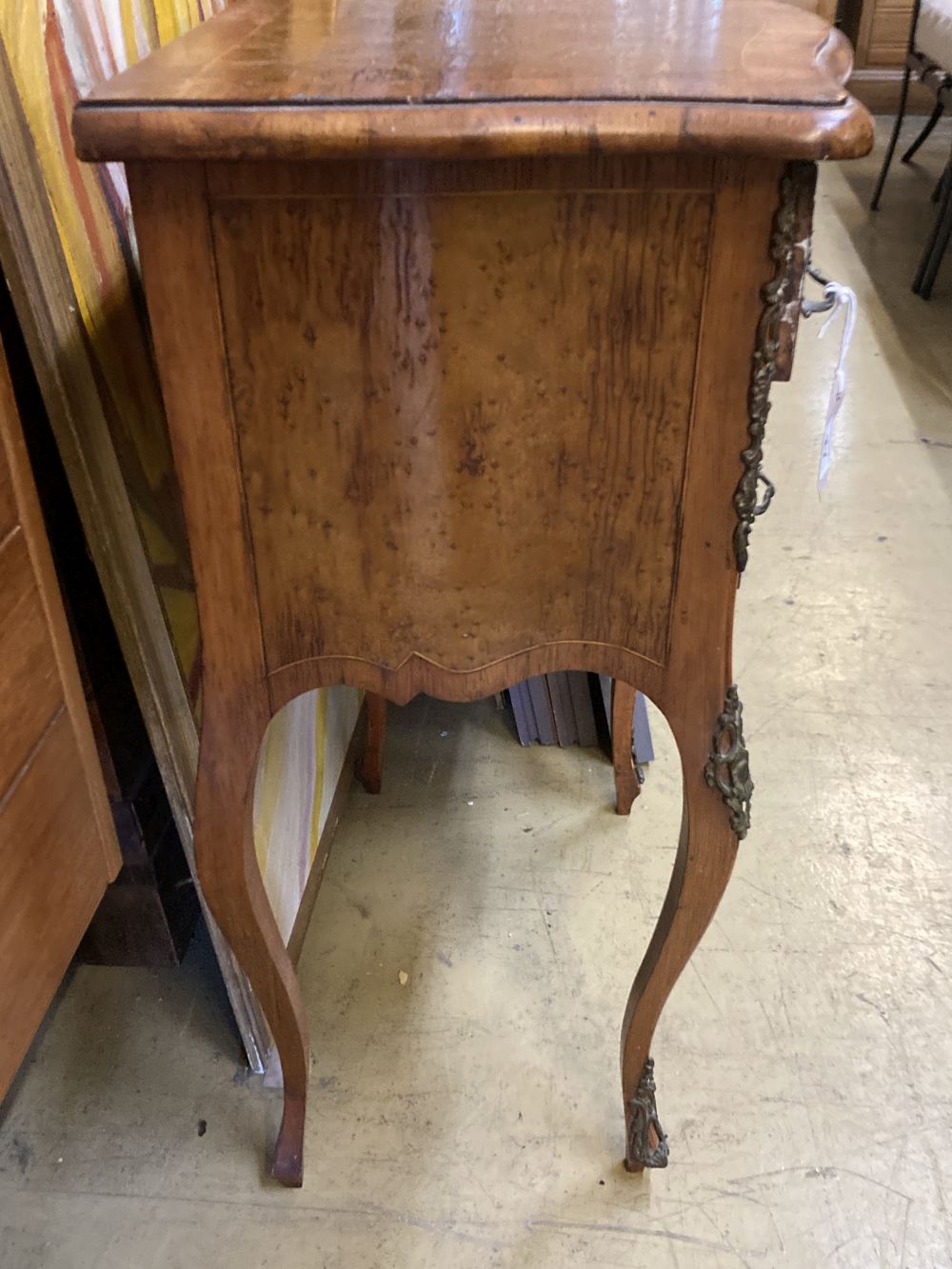 A French kingwood birds eye maple porcelain mounted serpentine two drawer bedside cabinet, width 50cm, depth 34cm, height 72cm